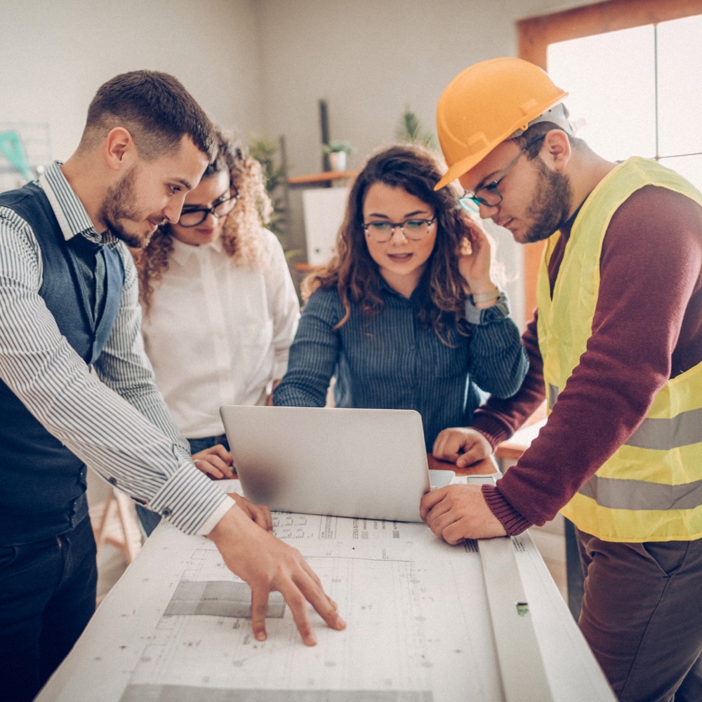 Owner's representative advising a project team around a laptop